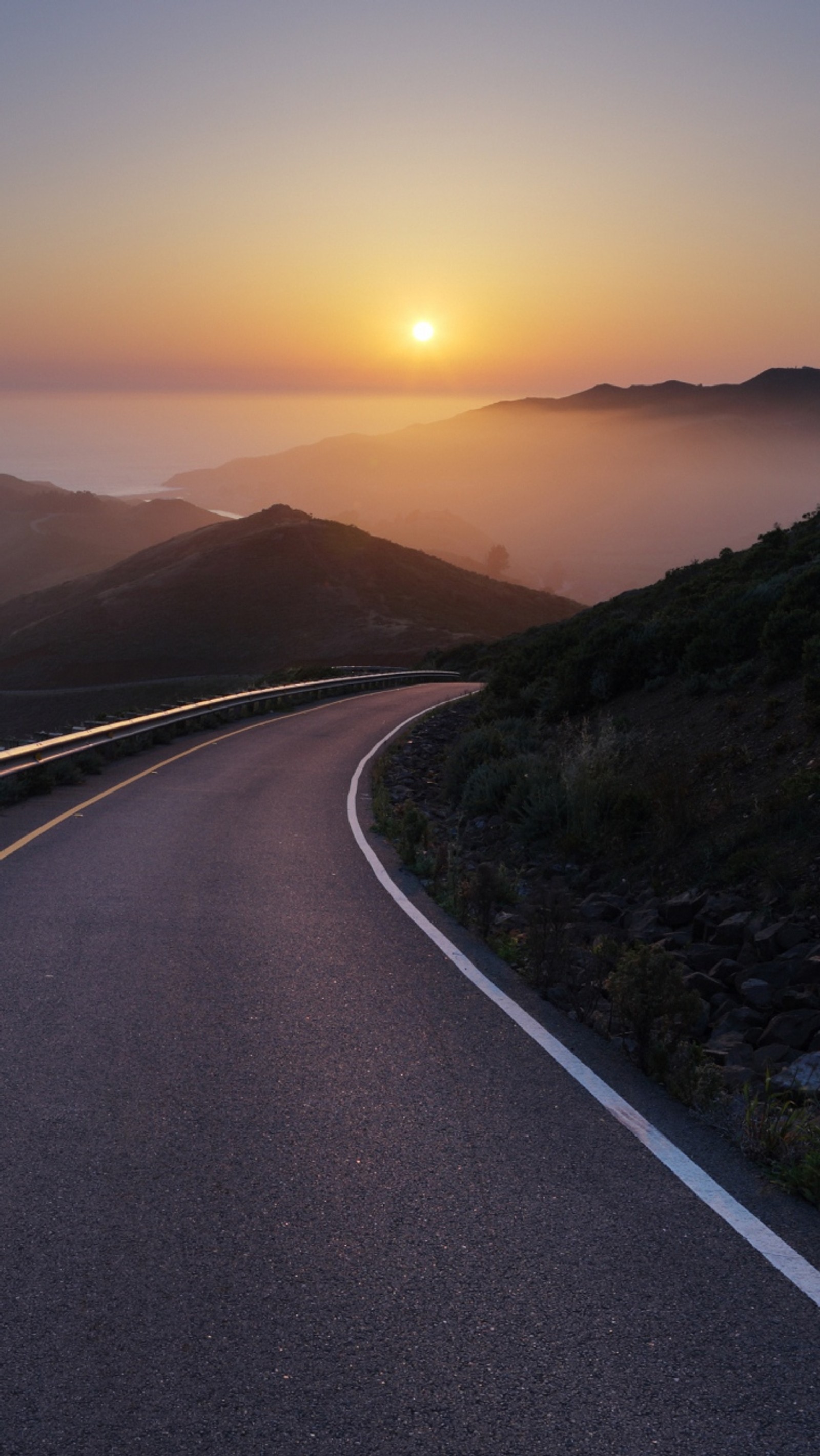 Arafed road going down a hill with a sunset in the background (background, cool, hd, nature, nice)