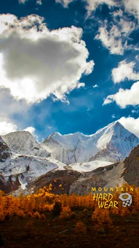 Majestic snow-capped peaks with vibrant autumn foliage, showcasing Mountain Hardwear's spirit of adventure.