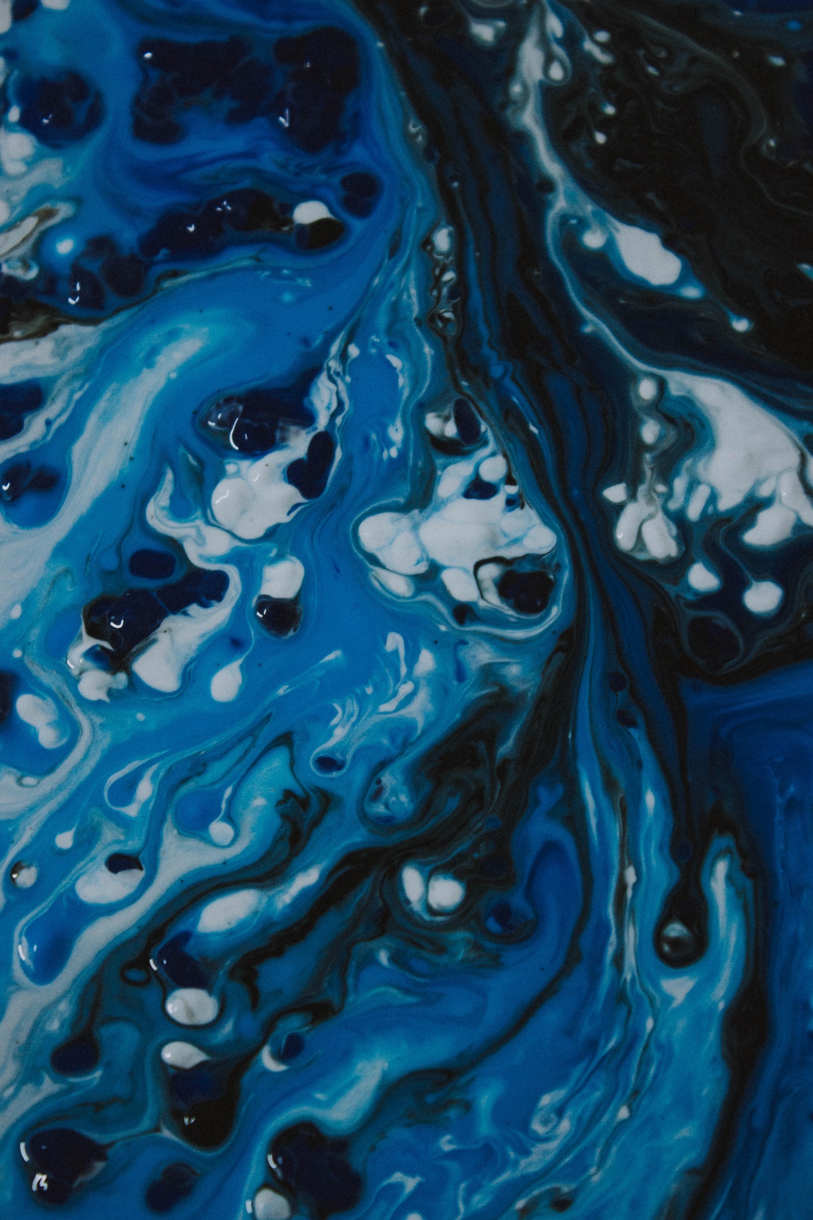 A close up of a blue and black painting with white dots (paint, painting, abstract art, art, blue)