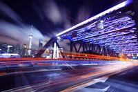 Vibrant Night Cityscape: Illuminated Bridge Overflowing with Urban Energy