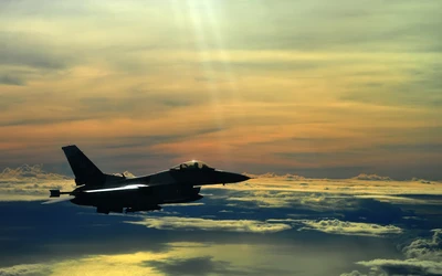 Fighter Jet Flying Above the Clouds at Sunset