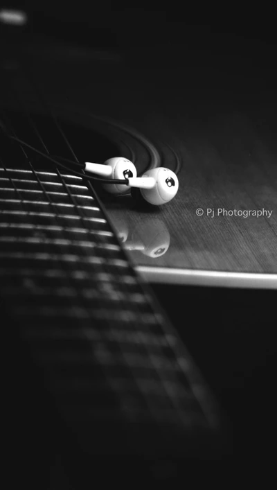 Melody of Faith: Guitar and Earbuds Unite