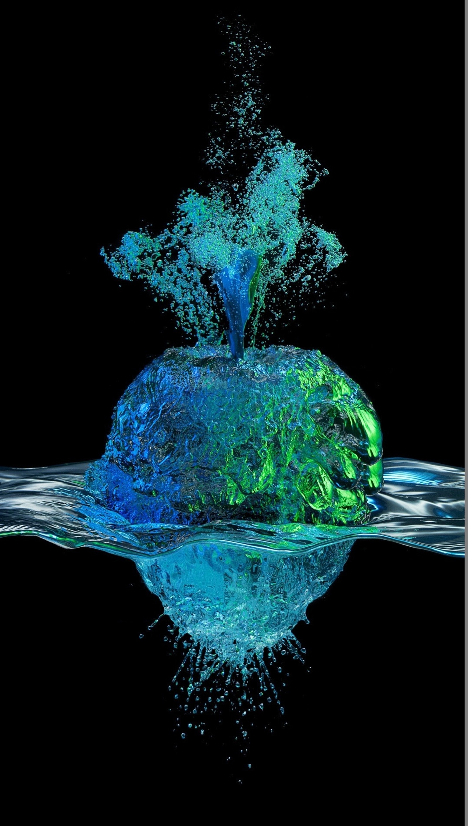 Un gros plan d'un objet liquide vert et bleu dans l'eau (pomme, art, fantaisie, eau)