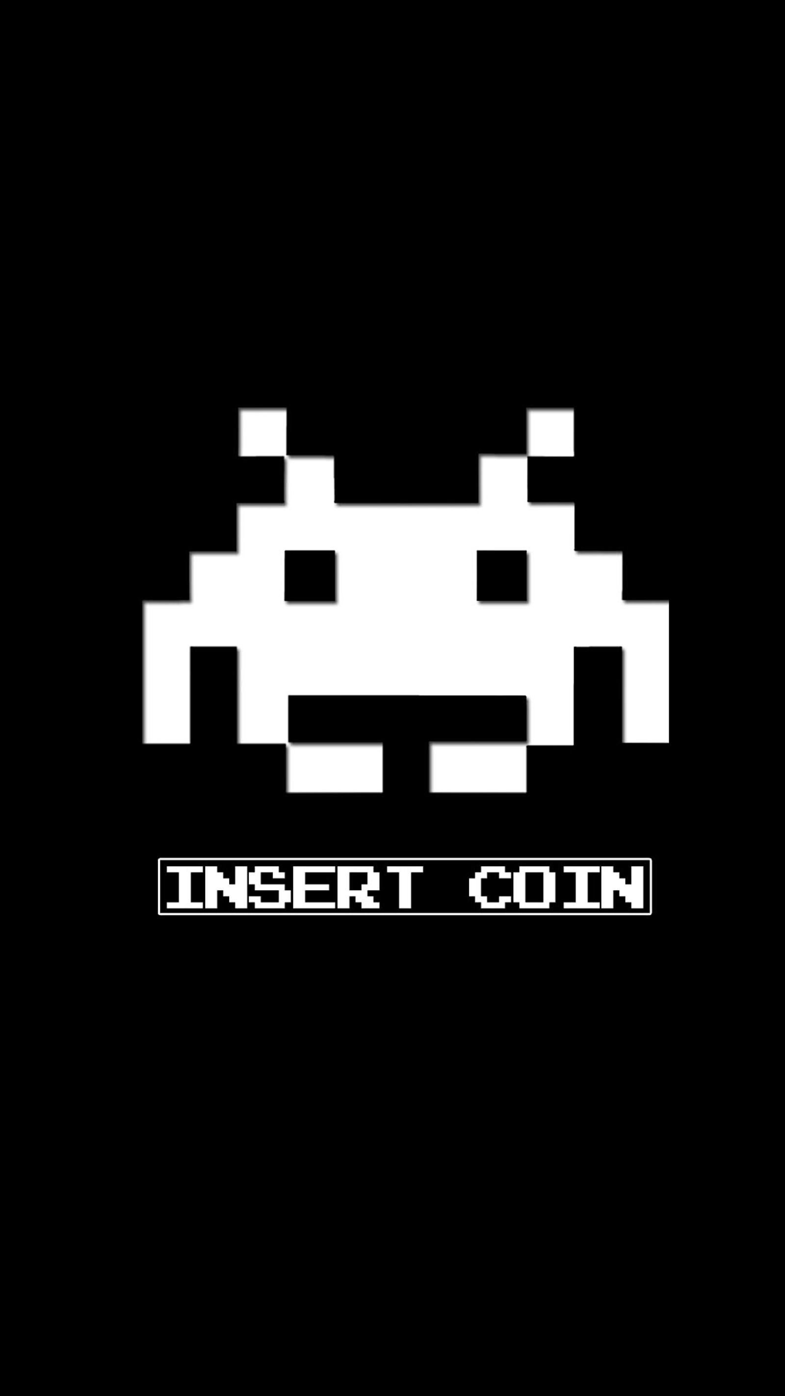 A black and white photo of a space invader with the word insert gun (arcade, coin, funny games, insert)