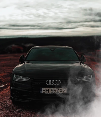 Sleek black Audi A7 emerging from foggy terrain, embodying luxury and performance.