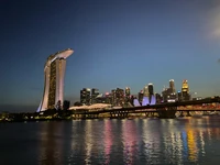 Illuminated Cityscape with Towering Skyscraper at Dusk