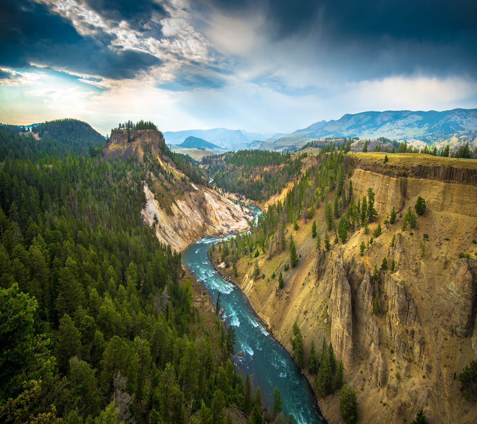 A view of a river flowing through a canyon surrounded by trees (canyon, creek, forest, mountain, river)