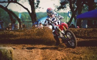 Freestyle Motocross Rider Navigating a Dirt Track