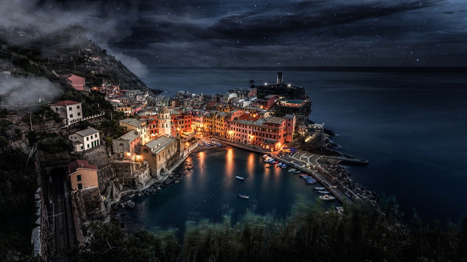 Uma vista de uma cidade em um penhasco com vista para o oceano (manarola, vernazza, natureza, noite, reflexo)