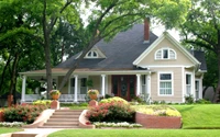 Charming Cottage Surrounded by Lush Landscaping in a Serene Residential Neighborhood