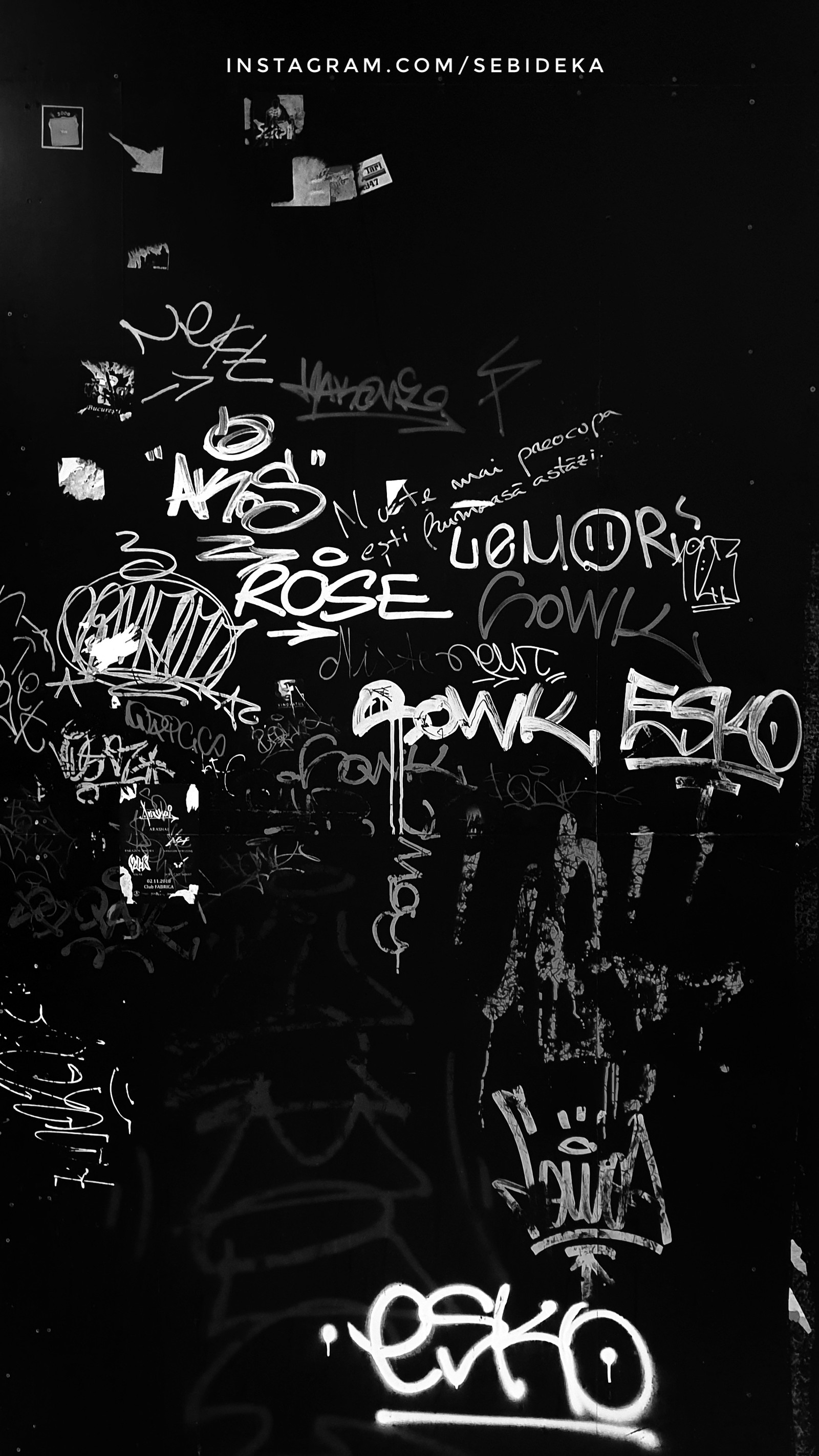 Graffiti on a wall in a dark room with a street light (black, dark, graffiti, logos, sebidk)