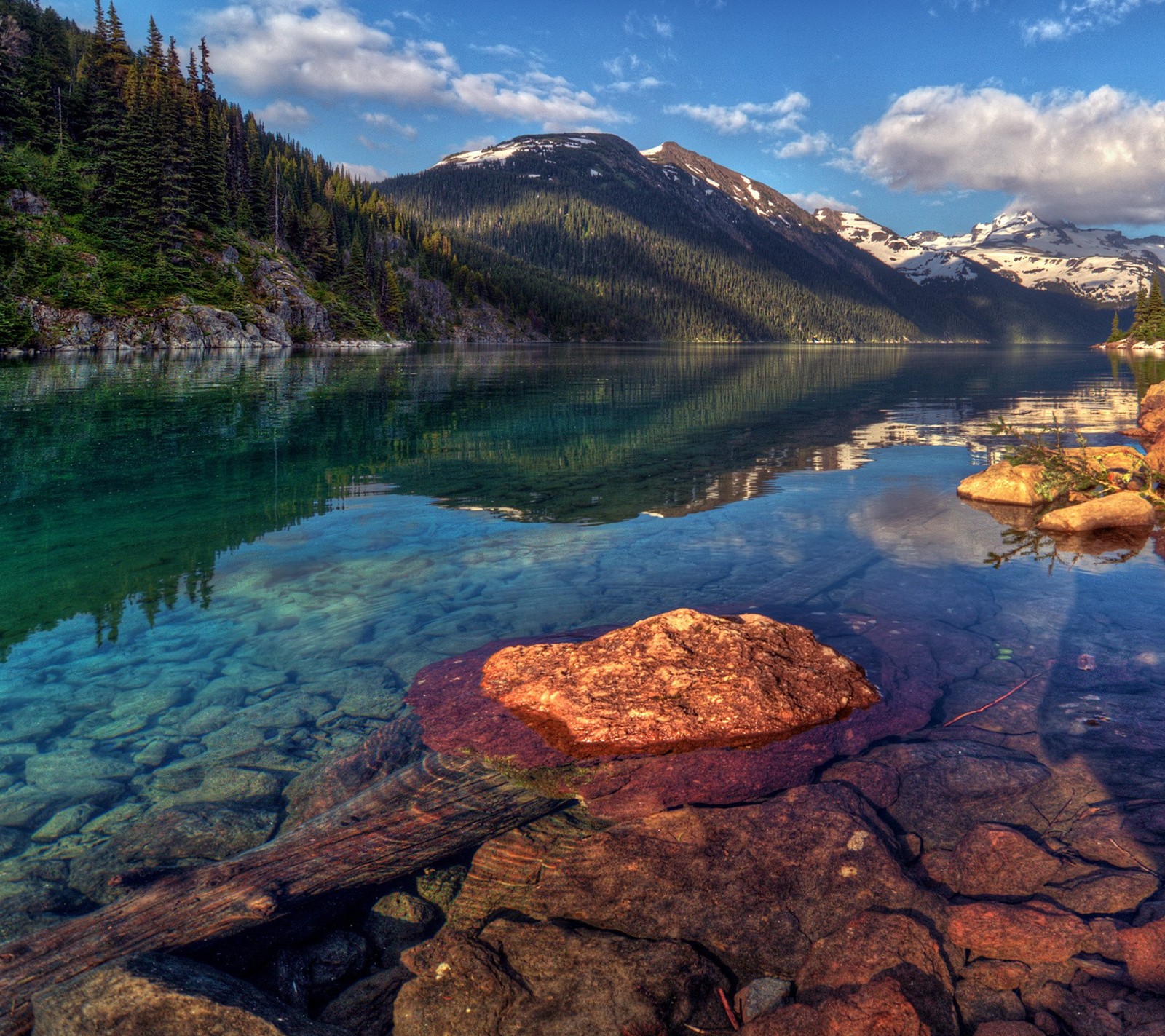 There is a large body of water with rocks in it (lake, landscape, mountain, nature)