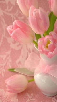 Delicate Pink Tulips in a White Vase with a Soft Bow