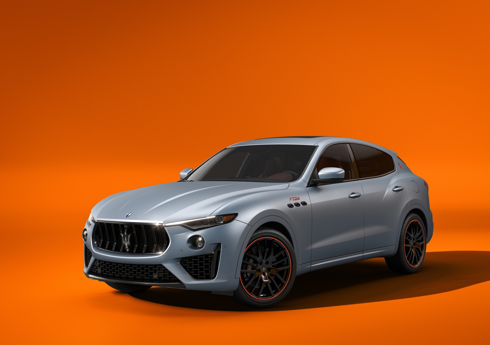 A silver mas car on an orange background (maserati levante f tributo, special edition, 2022, 5k, 8k)