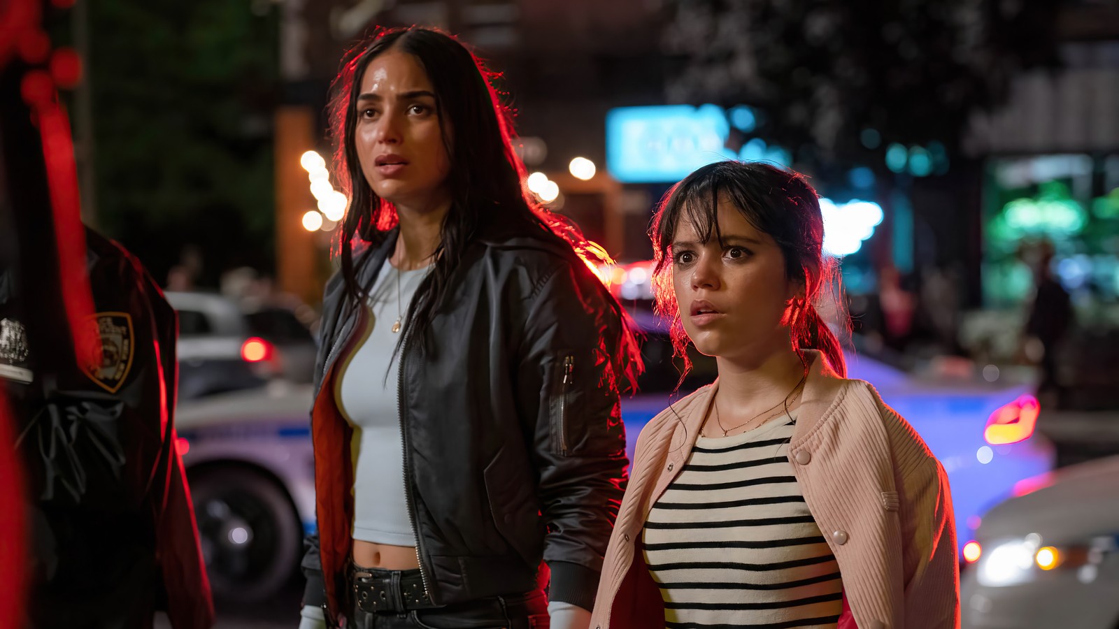 Two women walking down a street at night with a police officer (scream 6, movie, 2023, scream vi, jenna ortega)