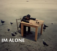 A solitary figure sits at a wooden table in an expansive, barren landscape, surrounded by seagulls, evoking a profound sense of solitude.