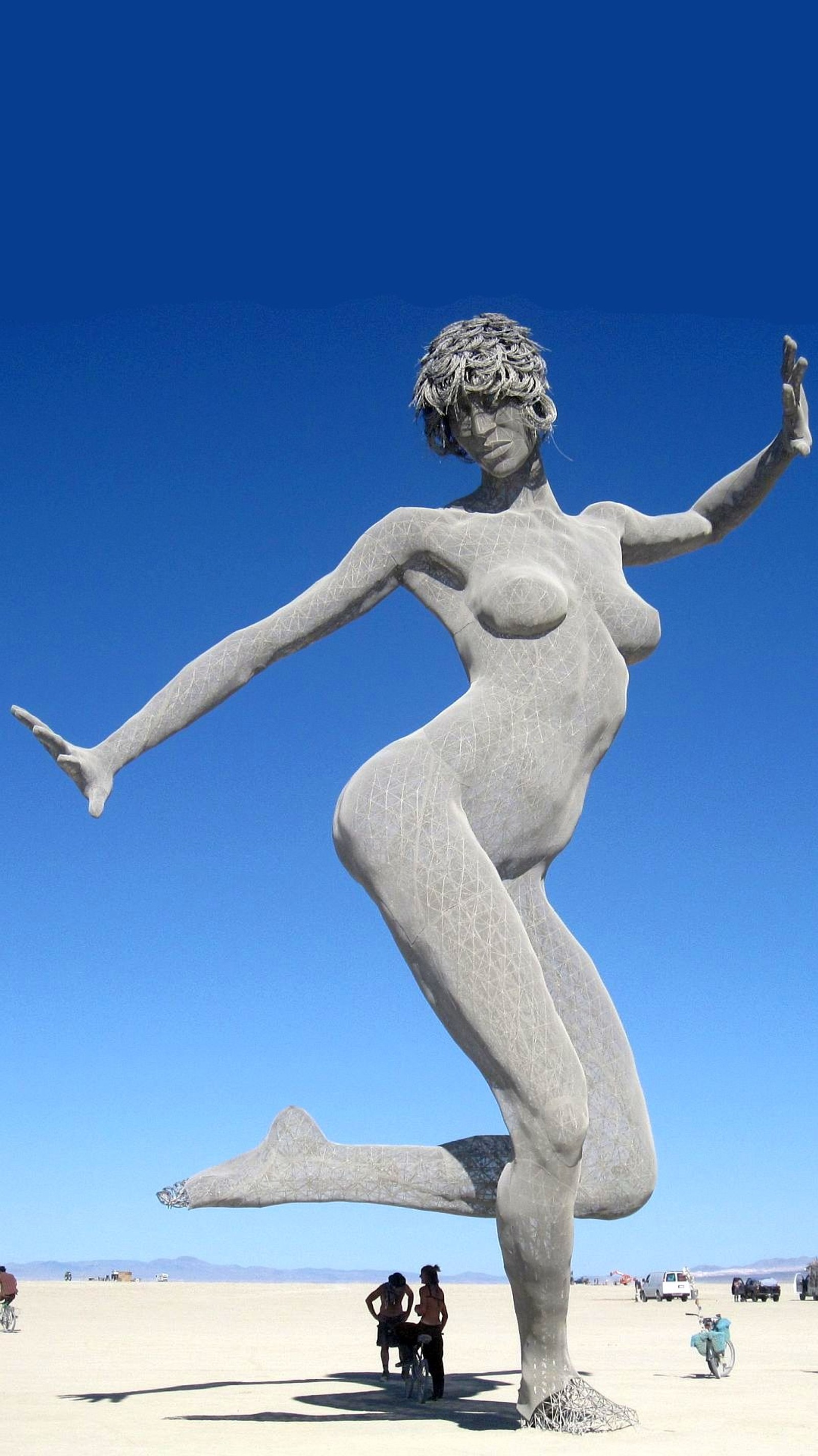 Araffe statue of a woman in a pose on a beach (black rock, burning man, desert, festival, nevada)