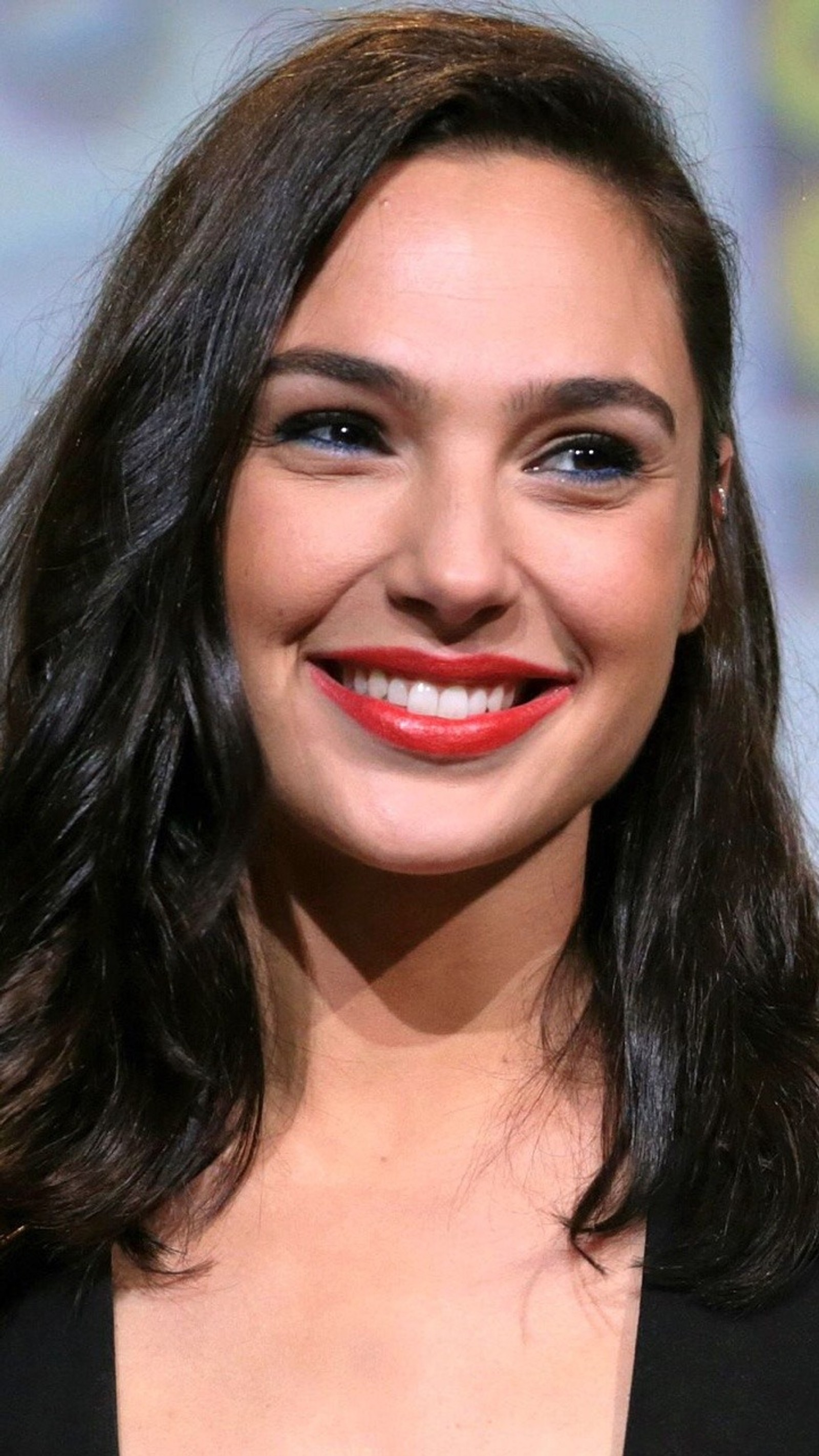 A close up of a woman with a red lipstick smiling (gadot, gal, woman, wonder)