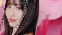 Hirai Momo radiates charm with sparkling accessories against a vibrant pink backdrop in this K-pop subunit trailer.