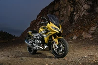 BMW R 1250 RS Sport: Sleek Yellow Performance Motorcycle Against Rocky Backdrop