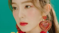 Irene with heart-shaped earrings and striking makeup, embodying the vibrant style of K-pop.