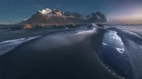 Majestic Mountain Range Overlooking a Serene Coastal Landscape at Dusk