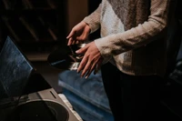 Musician Handling a Vinyl Record at a Turntable