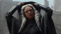 Ahsoka Tano in einem dramatischen Moment, der ihre ikonischen Merkmale und Kleidung aus der Serie "Ahsoka" zeigt.