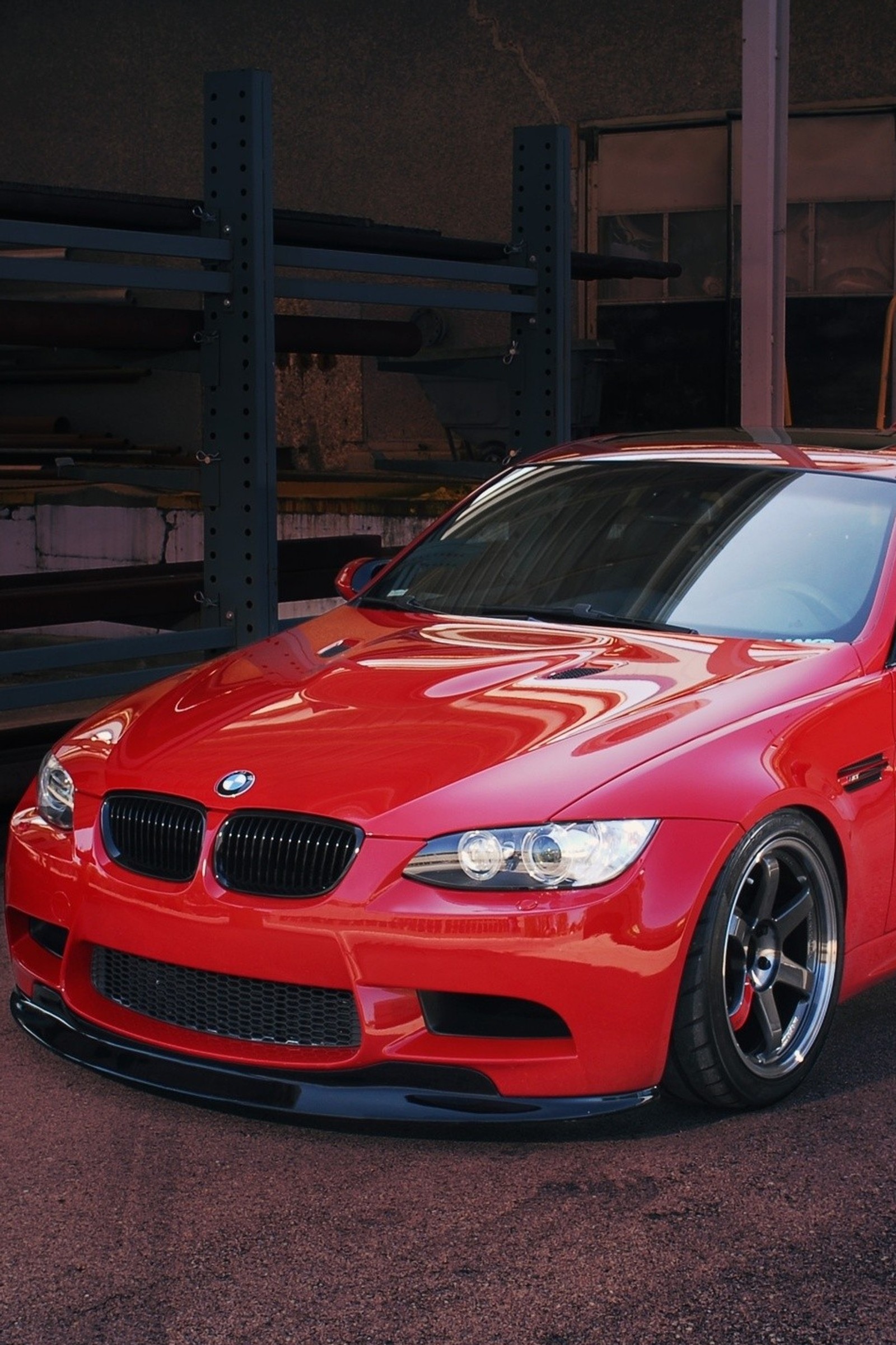 Arafed red bmw car parked in a garage with a rack of shelves (bmw, bmw red, car, red)