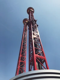 Iconic Red Iron Towers Against a Clear Blue Sky