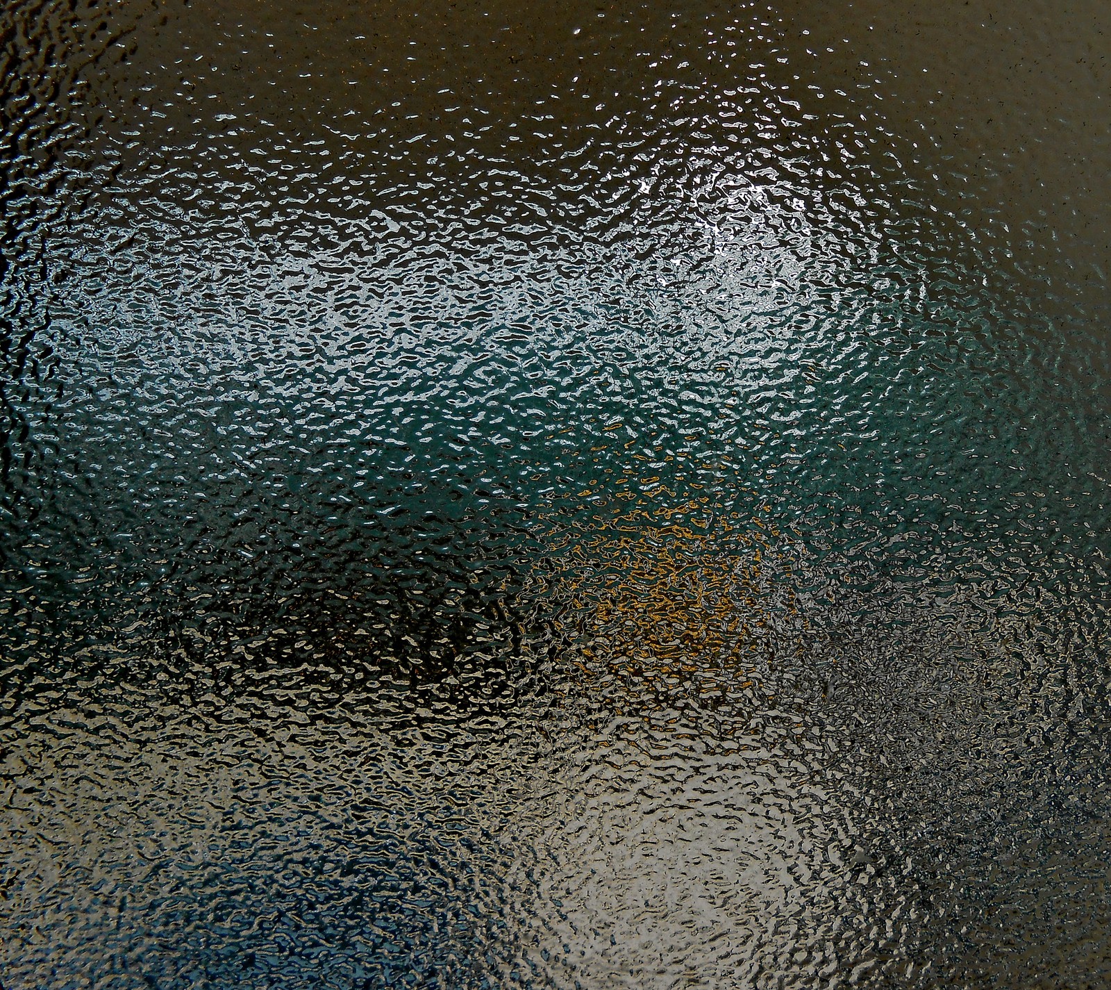 A close up of a glass window with a blue sky in the background (abstract texture, pattern wet)