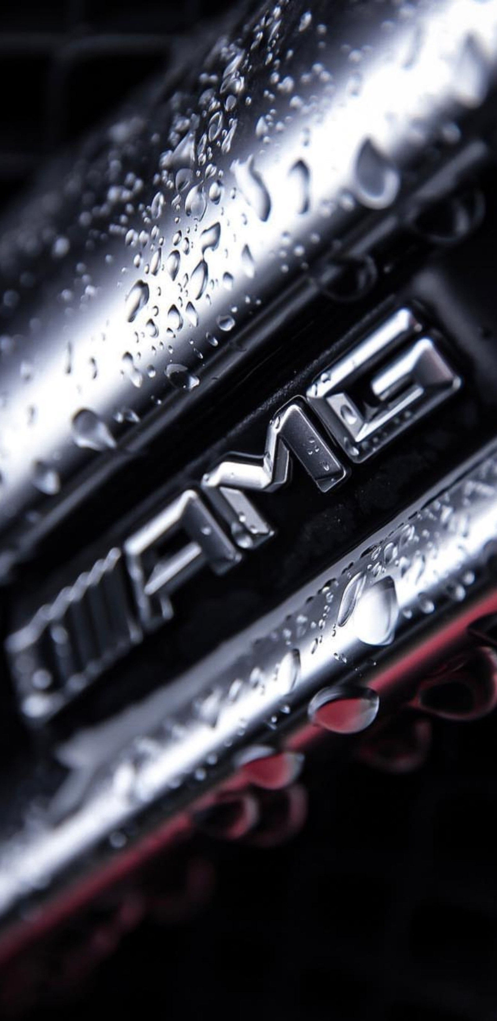 A close up of a shiny emblem on a shiny car (amg, black, car, design, hd)