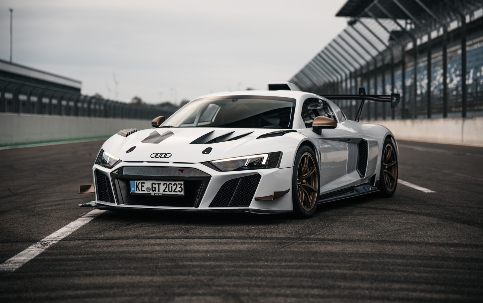 Audi r8 race car on track with a driver in the background (audi r8 lms gt2, custom tuning, 5k, race track, cars)