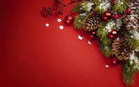 Festive Pine and Fir Arrangement with Red Ornaments on a Red Background