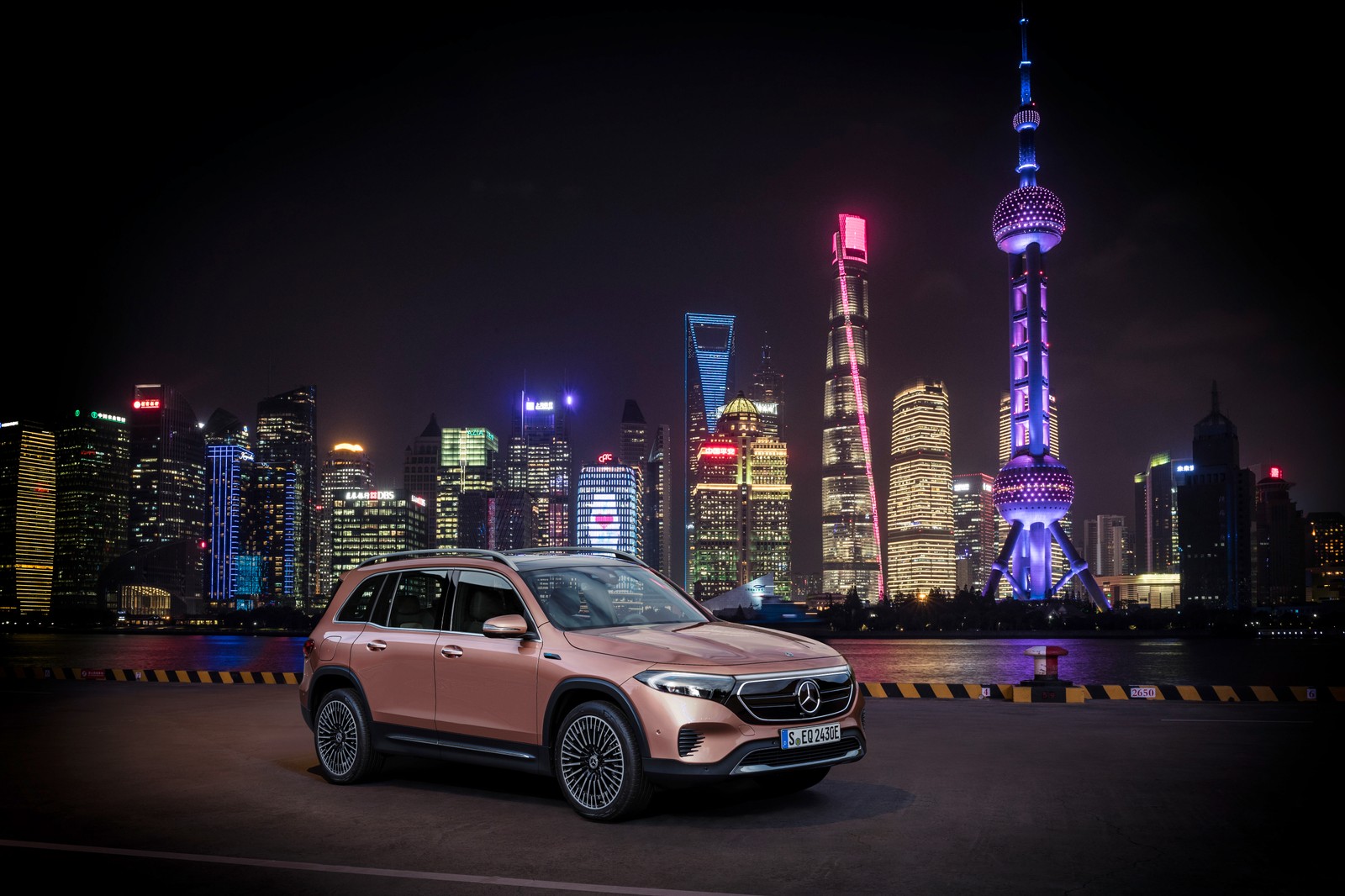 A pink mercedes suv parked in front of a city skyline (mercedes benz eqb 350 4matic electric art line, hong kong city, night, cityscape, skyline)