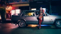 Ningning from aespa striking a confident pose beside a vintage car in an urban night setting.