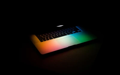 Illuminated Apple MacBook Pro in a Dark Setting