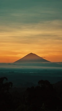 Majestic Mountain at Dusk: A Vibrant Sunset Over Highland Peaks