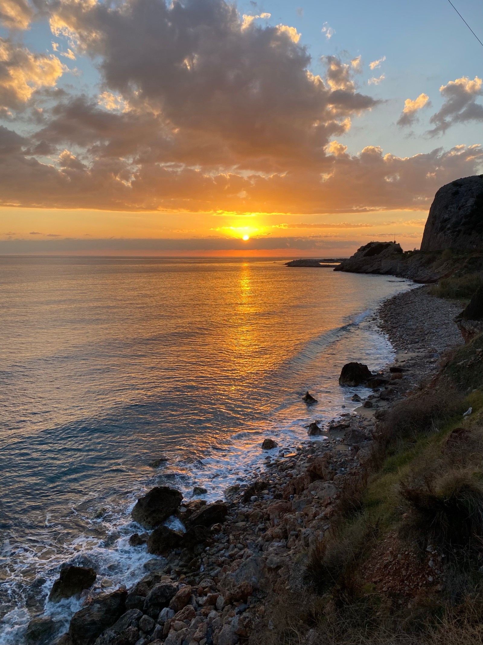 Sunset over the ocean with a train on the tracks (coast, cloud, water, water resources, atmosphere)