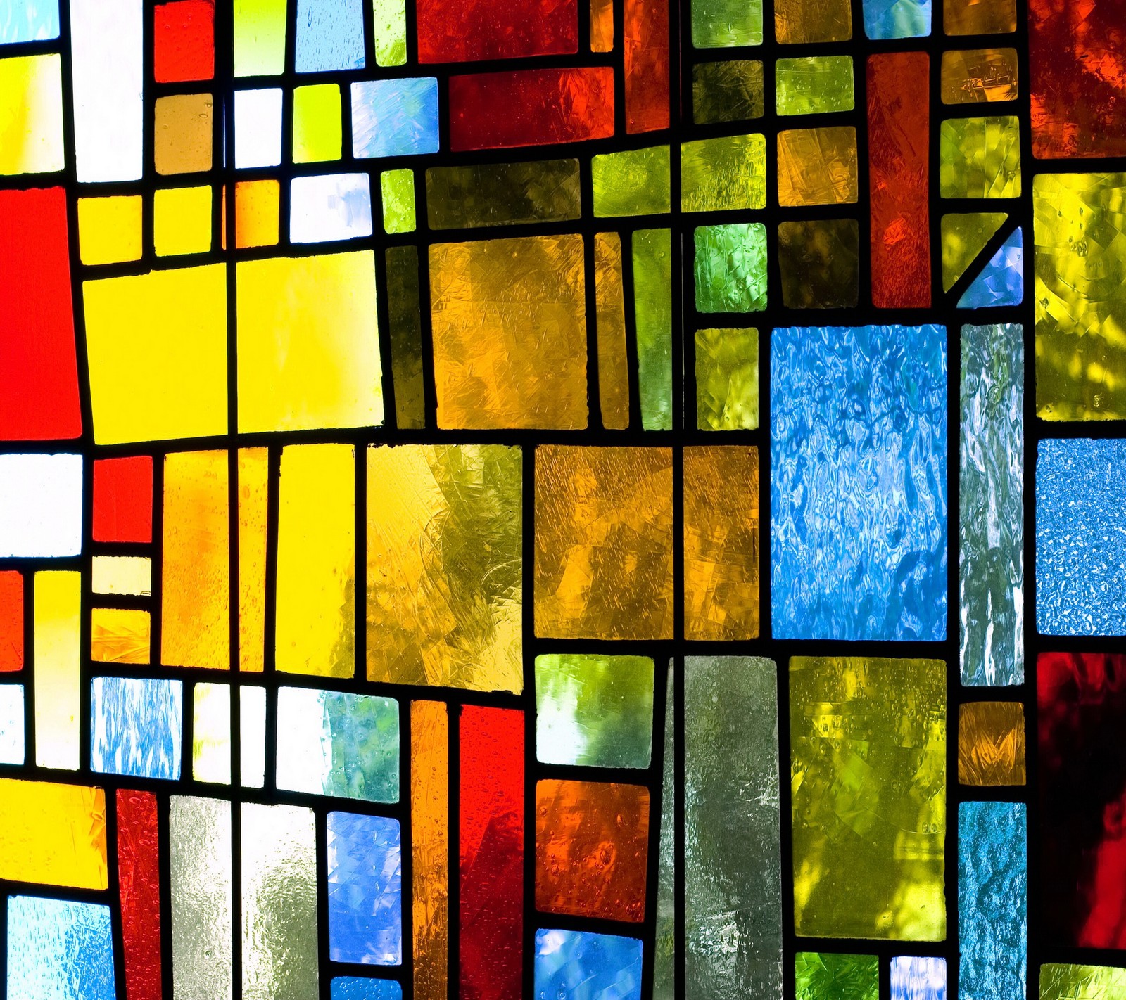 A close up of a stained glass window with a lot of colors (colorful, glass, mosaic, stained, window)