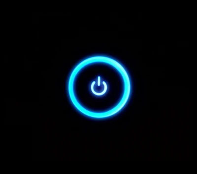 Illuminated Power Button on Black Background