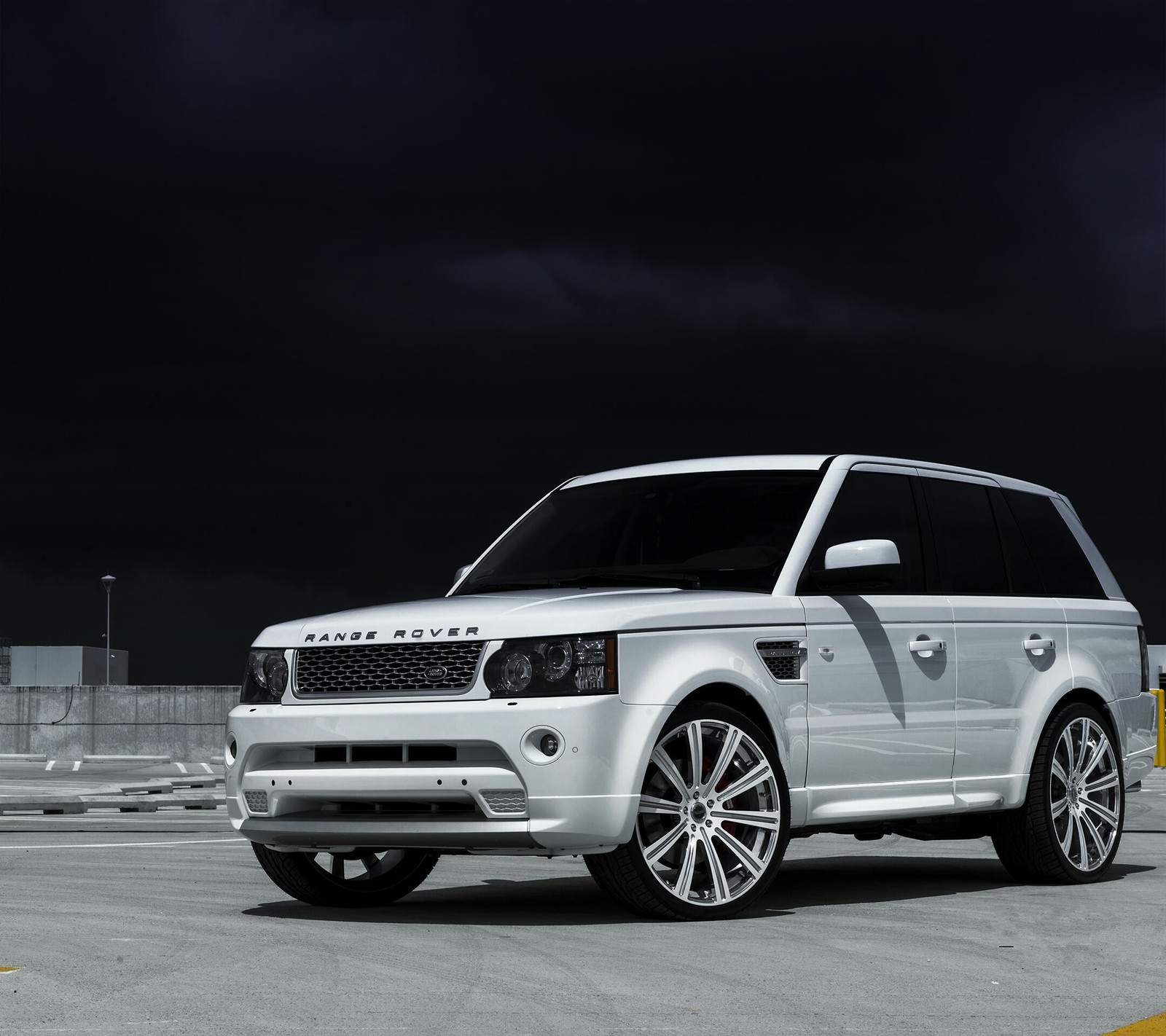 A close up of a white land rover parked in a parking lot (car, vehicle)