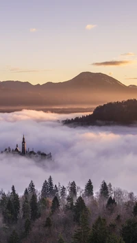 Majestic Highland Landscape with Mist-Covered Mountains and a Serene Church