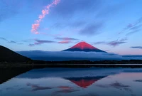 Majestueux Mont Fuji à l'aube : Un reflet serein sur des eaux calmes