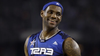 LeBron James smiling in a blue jersey during an NBA competition event.