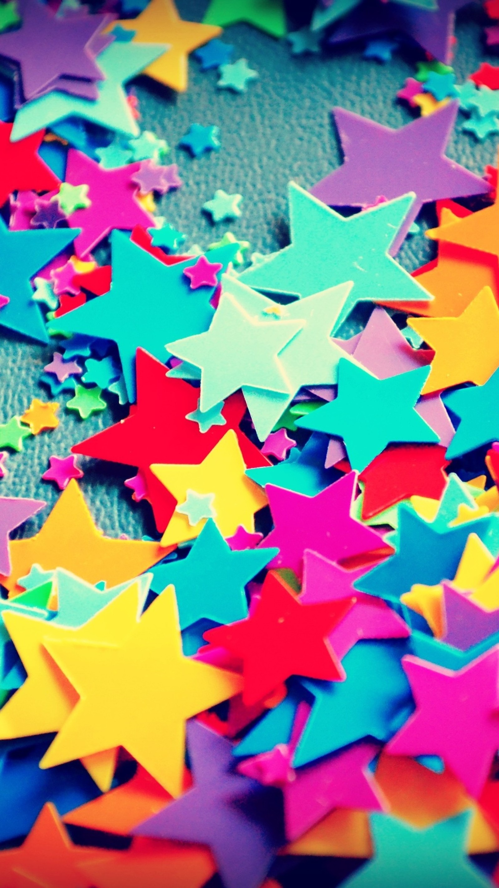 Brightly colored stars scattered on a carpet in a room (pattern, design, paper craft, art, paper)