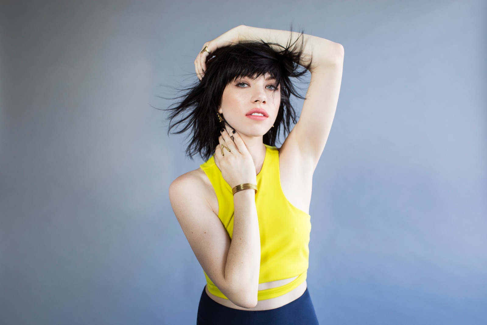 Arafed woman in a yellow top and black skirt posing for a picture (emotion, pop music, song, white, shoulder)