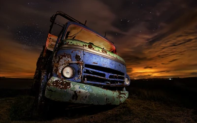 Rusty Truck Under Starry Sky at Night