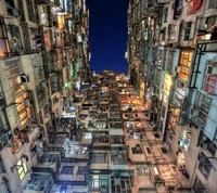 Vertical Cityscape: Illuminated Towering Apartments at Night