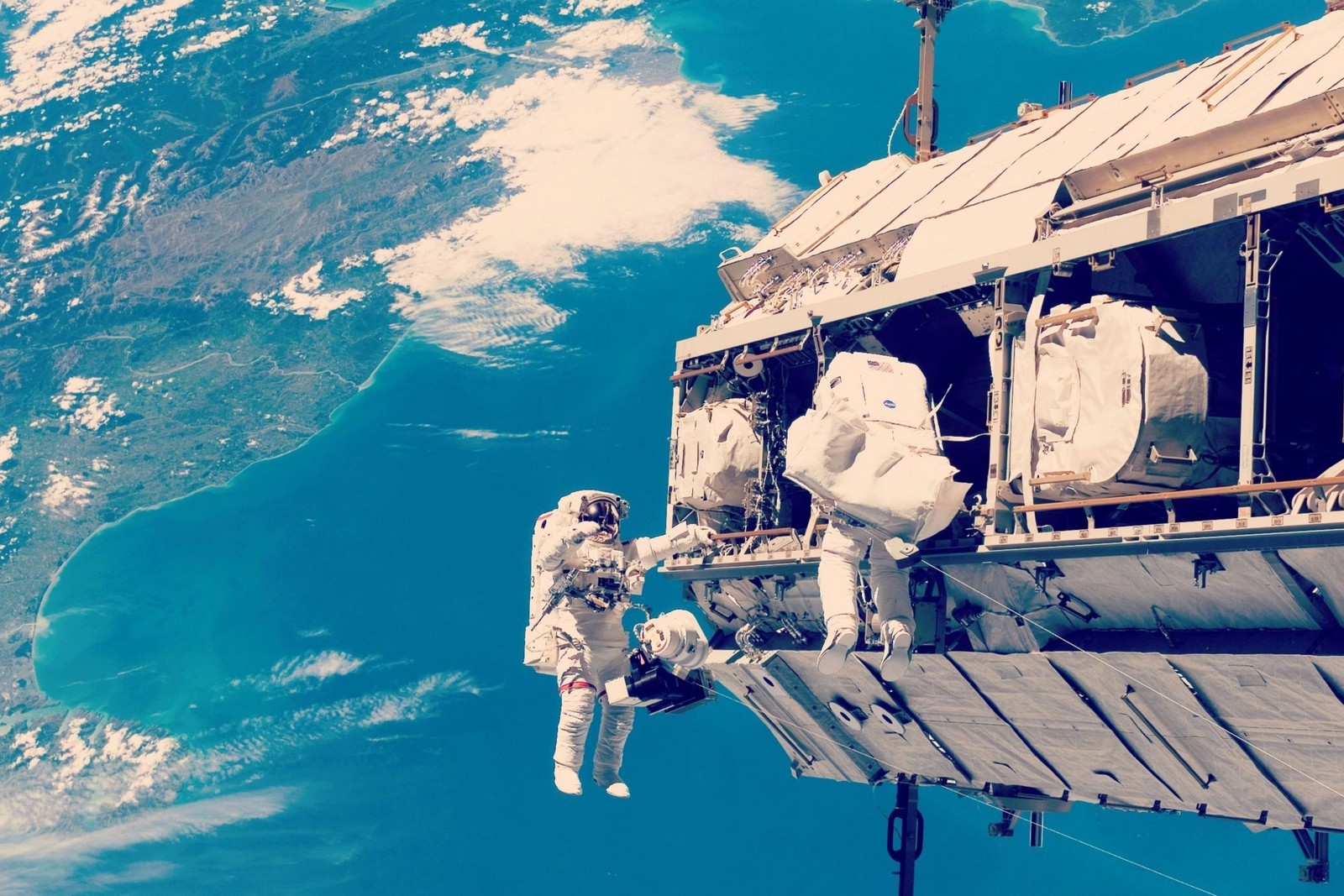 Astronaut in space suit in front of a space station (international space station, nasa, astronaut, outer space, space station)